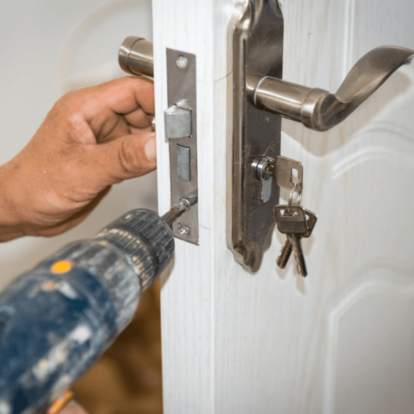 is johnson city tennessee good place to live - 10 Ways to Secure Your Home From Intruders and Burglars - a hand and a drill installing a new door lock (1)