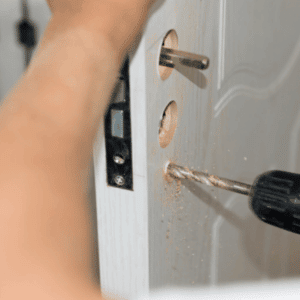 locksmith tri cities - Mistakes and Misconceptions You Should Avoid About Locks - a pair of hands working on installing a new doorknob with locks man checking the deadbolt of a front door