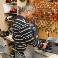 where can i get keys cut locally - The Benefits of Having a Master Key for Your Business - a locksmith working with a duplicating machine