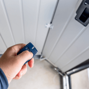 Best garage door lock - a remote control being used to open a garage door